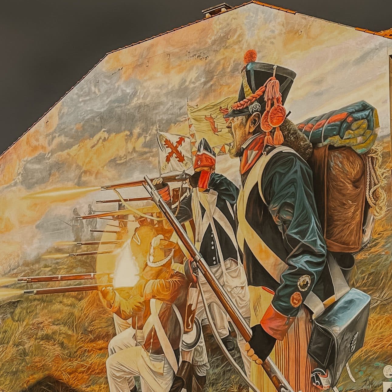 A large mural of Napoleonic-era soldiers painted on a village wall along the route.