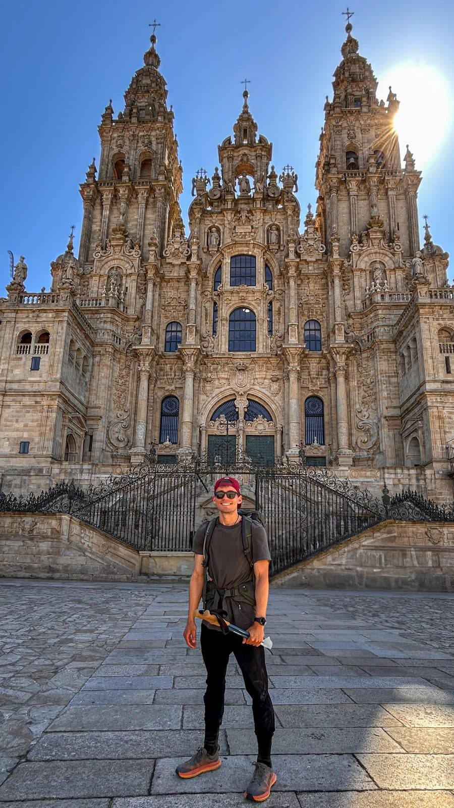 Kyle Wisniewski standing alone before the Cathedral of Santiago de Compostela at the end of 500 miles.
