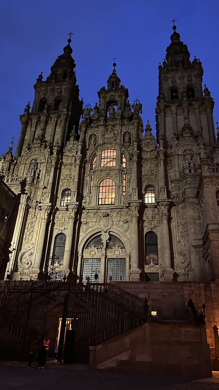 The Cathedral of Santiago de Compostela floodlit against the night sky.