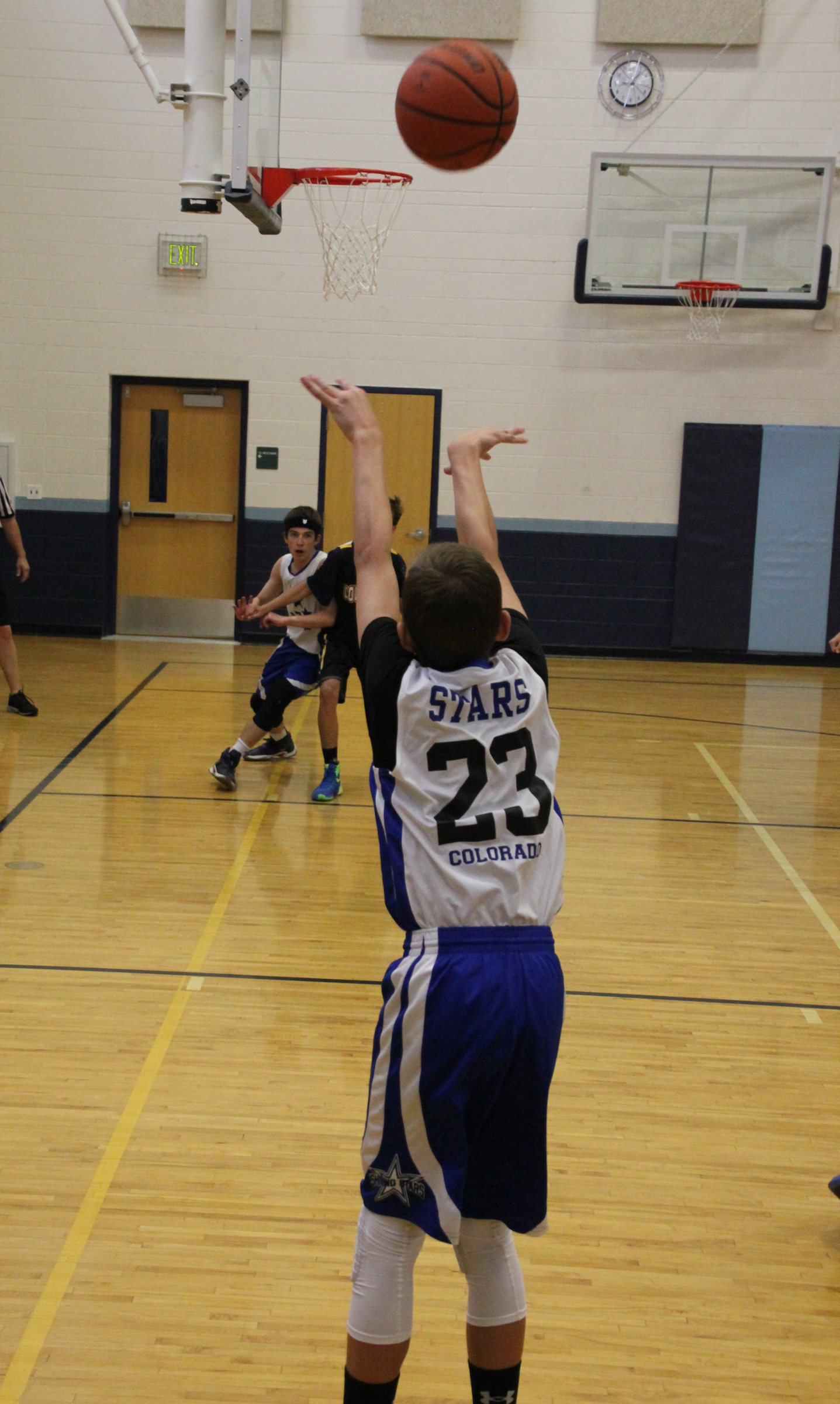 Kyle Wisniewski from behind in a white Stars jersey, number 23, shooting a free throw.