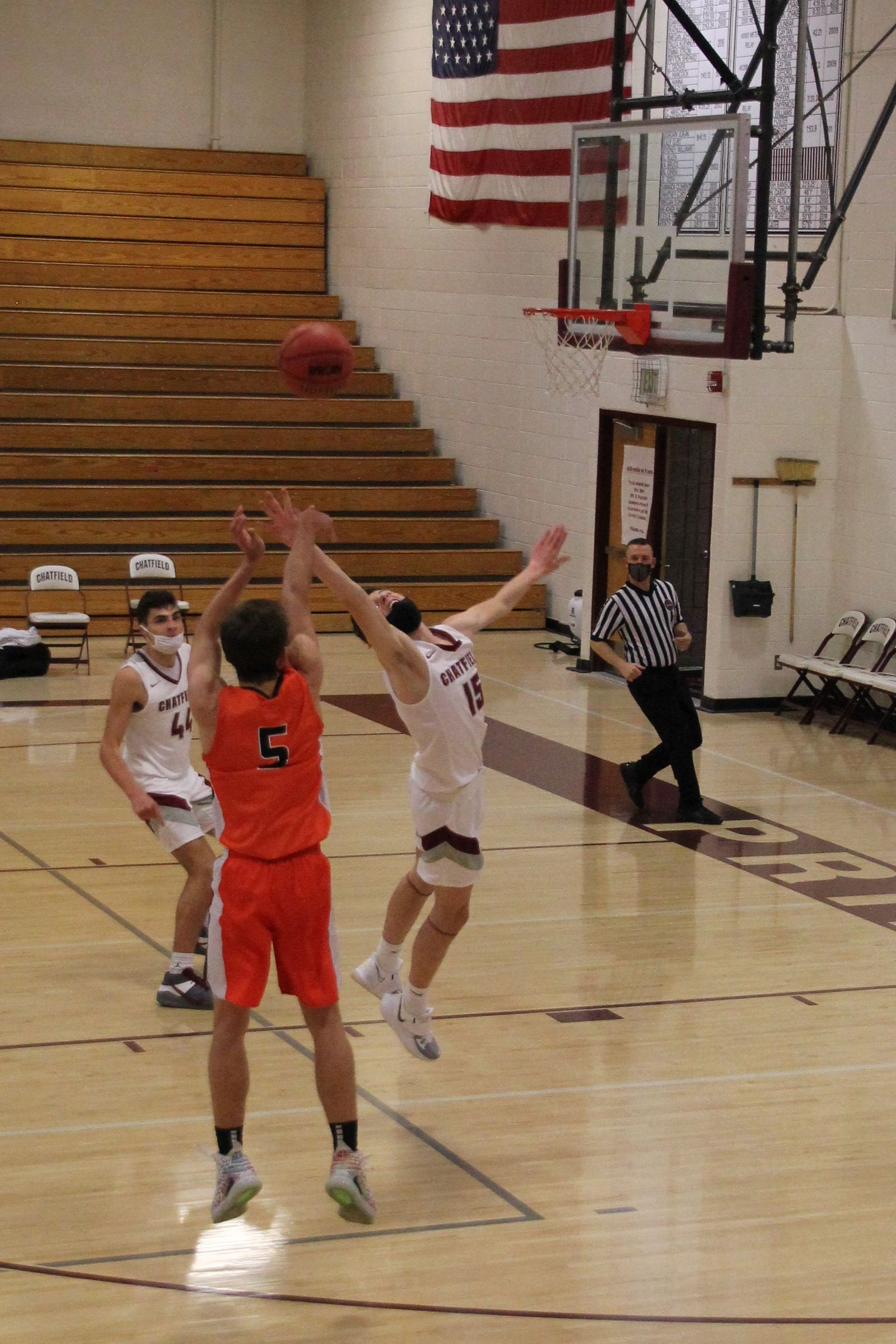 Kyle Wisniewski in an orange Lakewood jersey, number 5, rising for a jump shot as a defender contests.