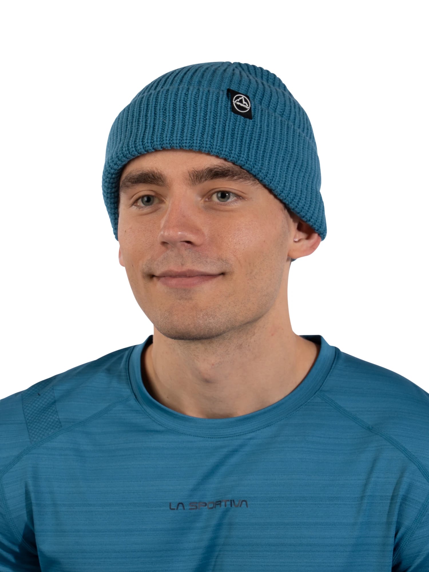 Kyle Wisniewski, head and shoulders, in a blue La Sportiva knit beanie and a matching La Sportiva T-shirt on white
